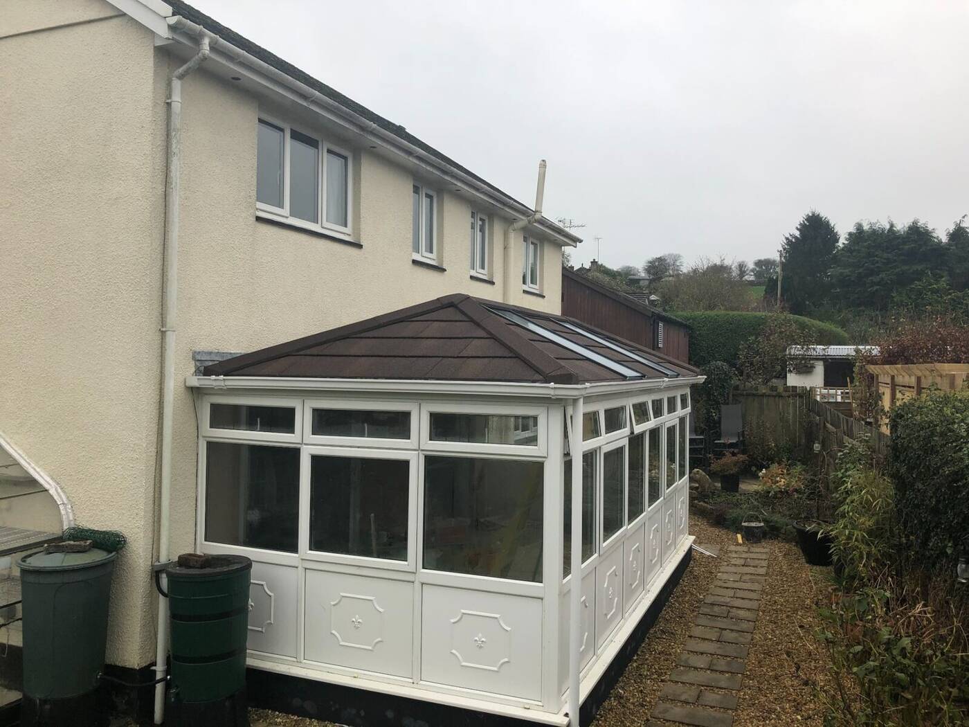 Devon conservatory after roof replacement with brown tiled warm roof and skylights
