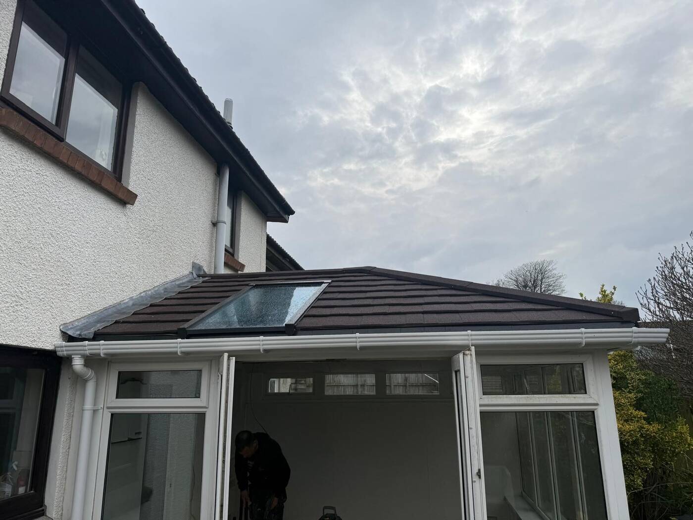 Guardian conservatory roof system being installed in Plymouth with brown tiled finish
