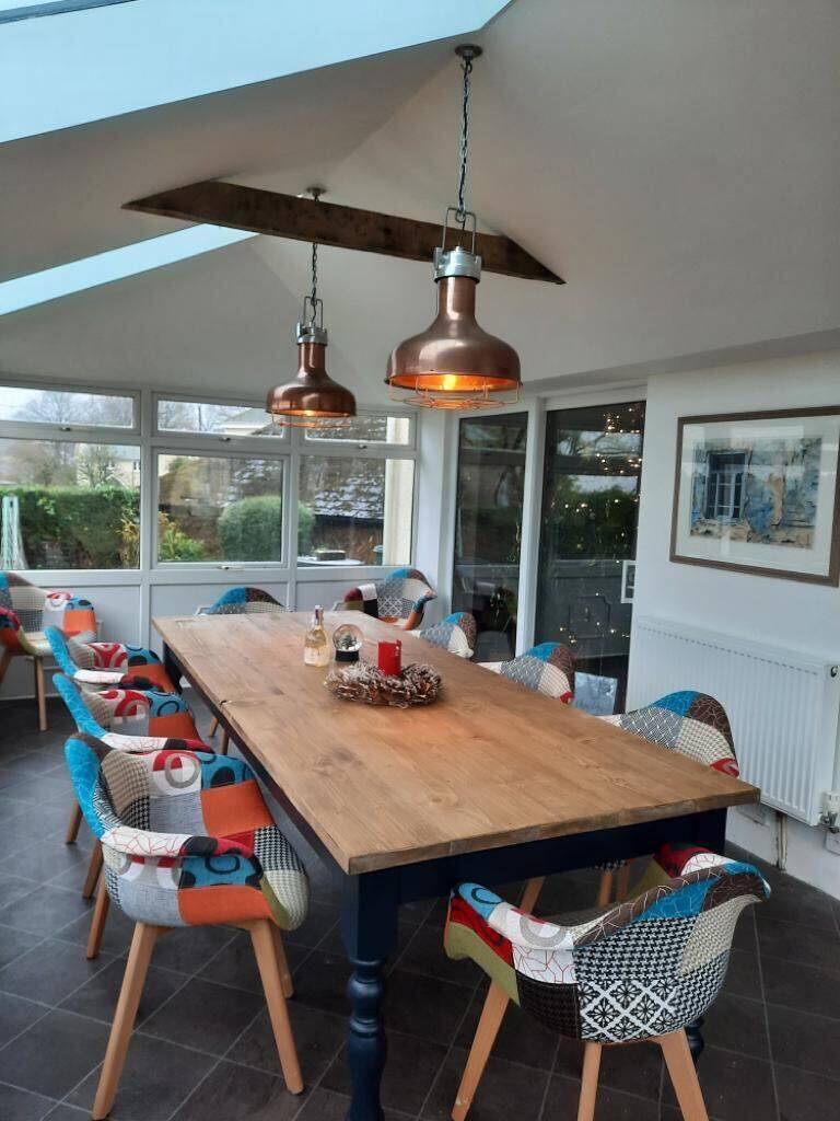 Interior view of a Plymouth conservatory with new insulated plastered ceiling and dining area