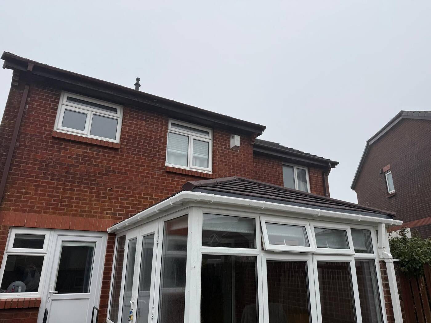 Conservatory roof replacement on a coastal Plymouth property with brown tiled finish