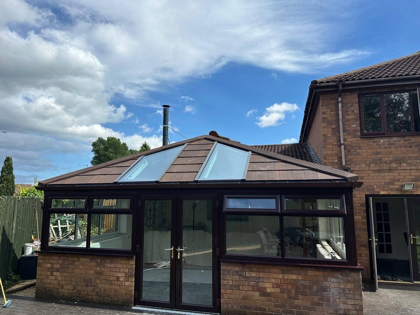 Conservatory roof replacement at scaffolding stage with new charcoal tiled roof