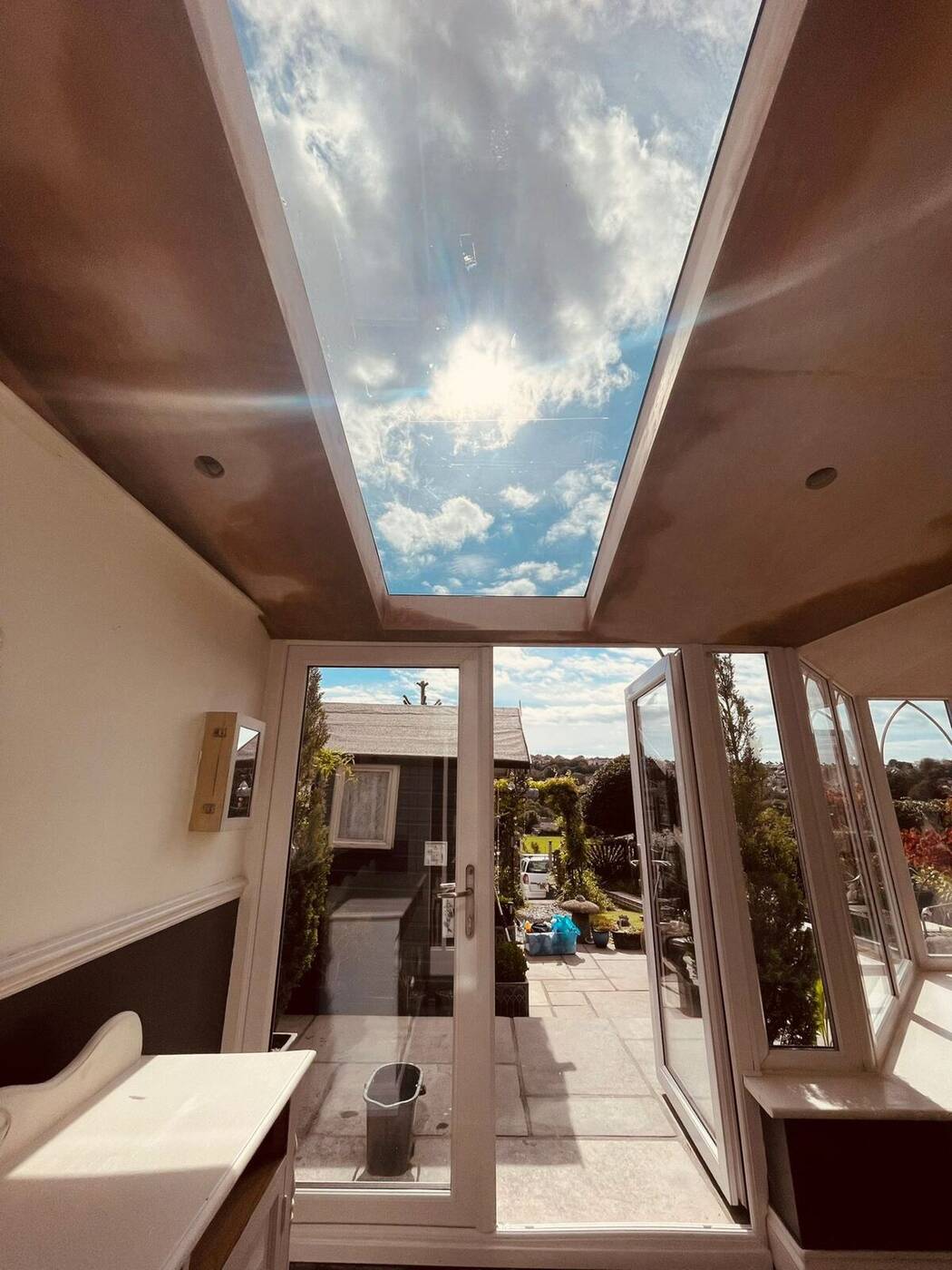 Interior view of a Plymouth conservatory with large central skylight in plastered ceiling
